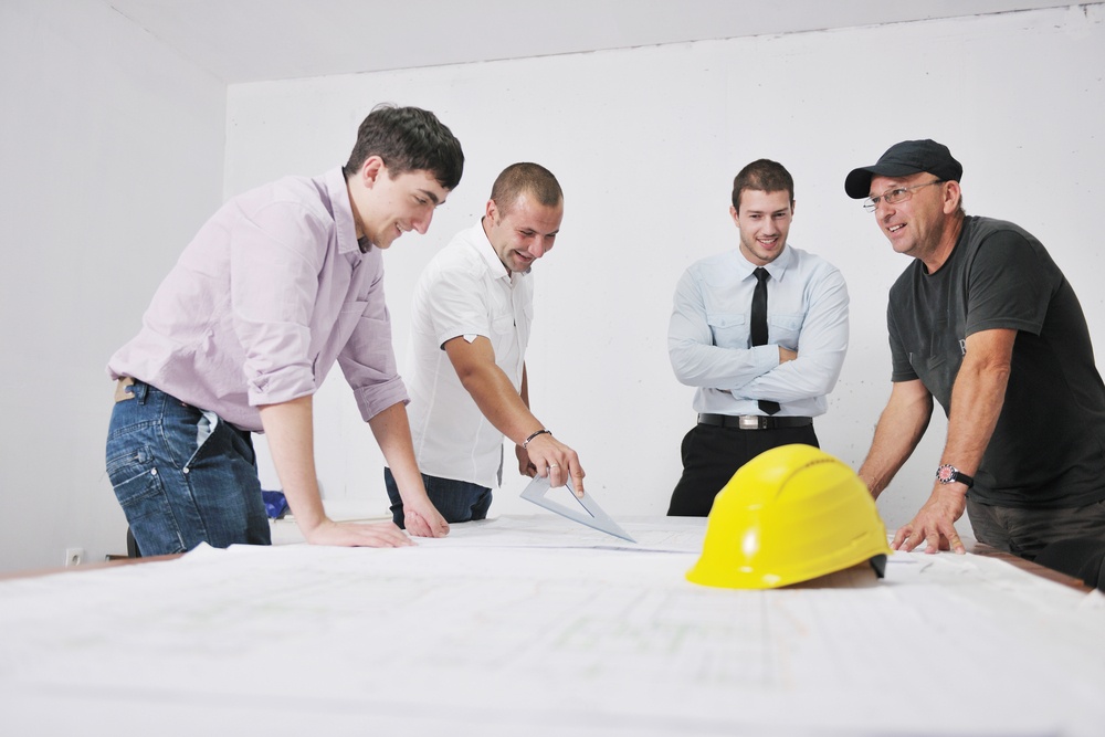 Team of business people in group, architect and engineer  on construction site check documents and business workflow on new building