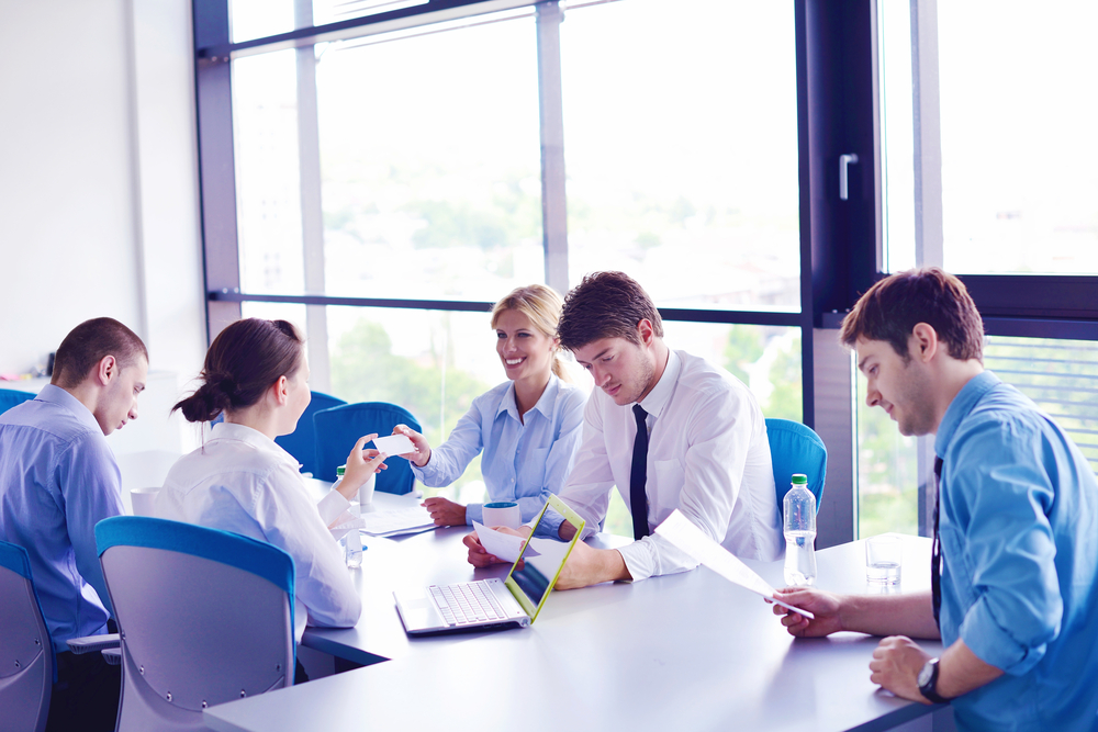 Group of happy young  business people in a meeting at office