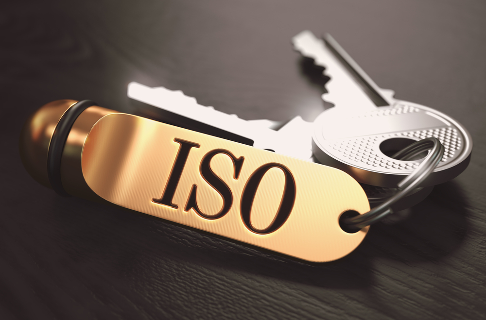 ISO - International Organization for Standardization - Concept. Keys with Golden Keyring on Black Wooden Table. Closeup View, Selective Focus, 3D Render. Toned Image.-1